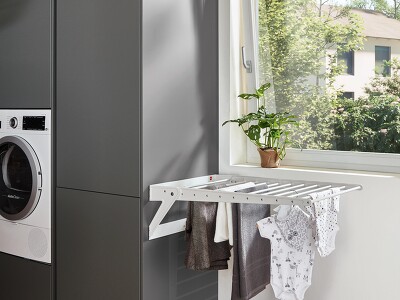 Äußerst funktional. An den schiefergrauen Schränken in TOUCH 334 ist ein ausklappbarer Wäschetrockner angebracht. Und wenn man ihn nicht braucht, einfach einklappen.